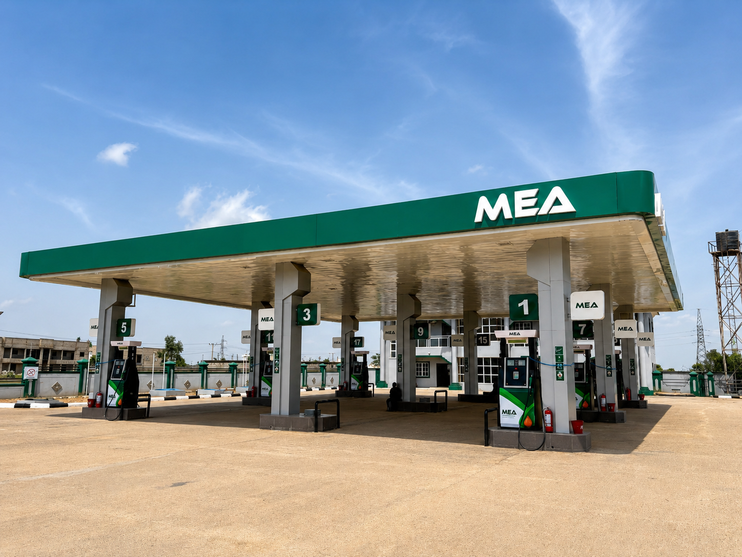 MEA-branded forecourt canopy under a clear blue sky