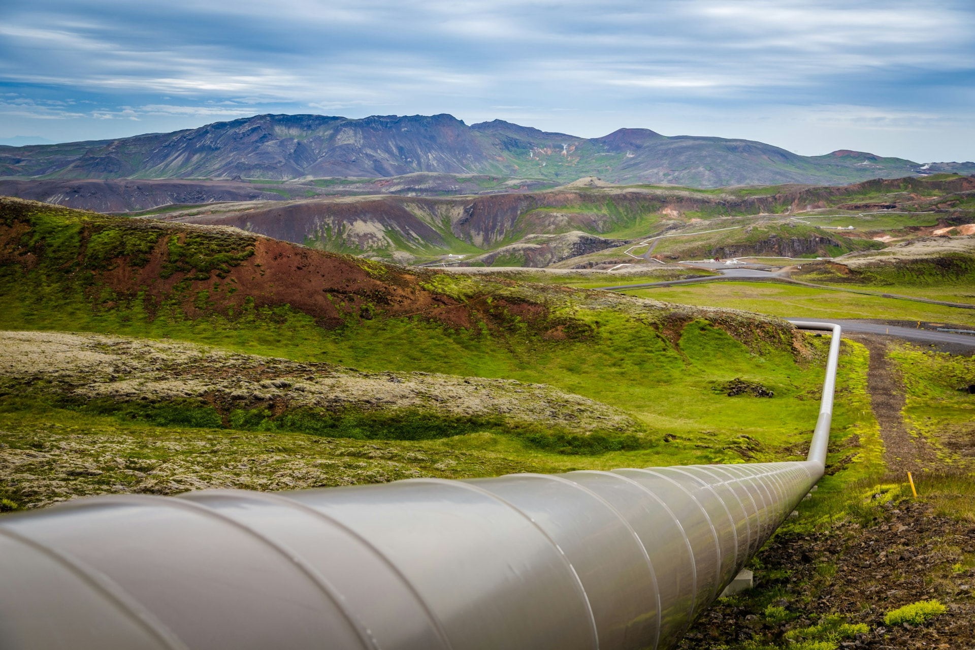 A pipeline crossing green hills