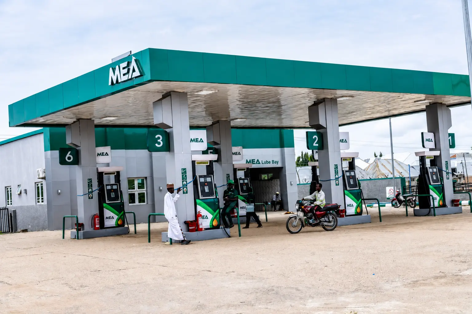 Customers and attendants at a busy MEA station forecourt
