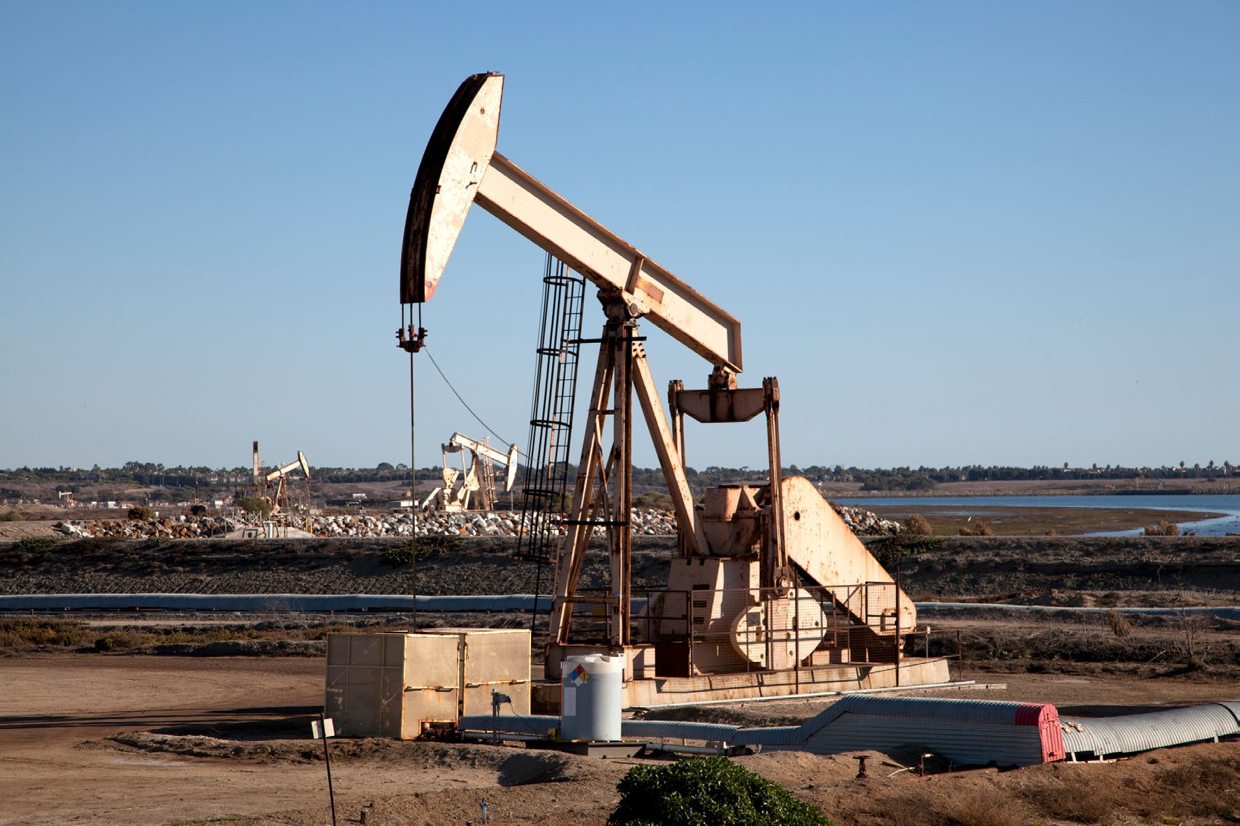 Oil production pump jack at sunset